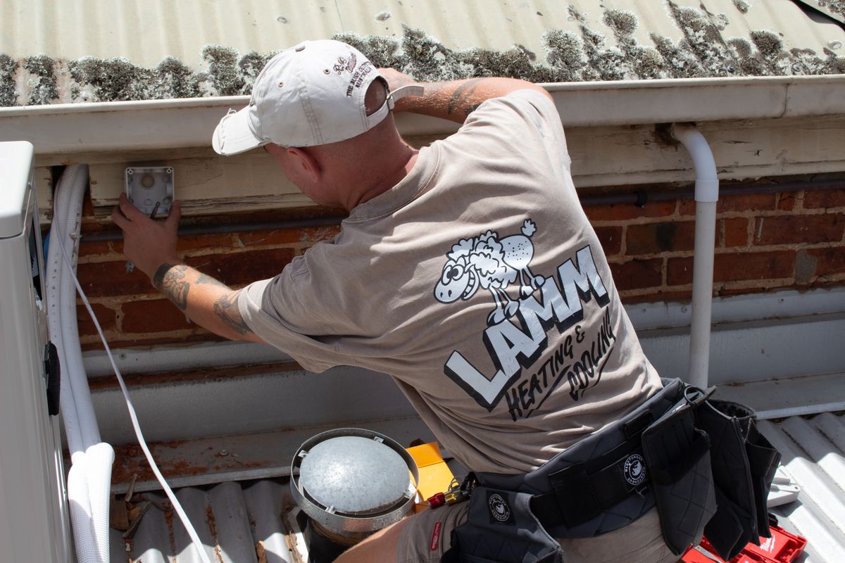 Jordi installing a wall-mounted split system
